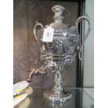 A silver plated urn and cover