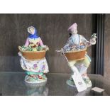 A pair of Meissen figures depicting vegetable and flower sellers, dot and cross swords mark, 21 cm
