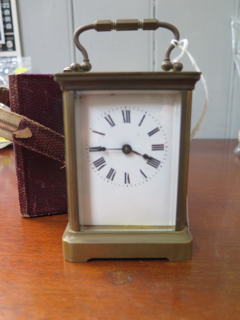 A brass carriage clock timepiece, of conventional form with enamel dial, and fitted case, 14 cm high