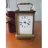 A brass carriage clock timepiece, of conventional form with enamel dial, and fitted case, 14 cm high