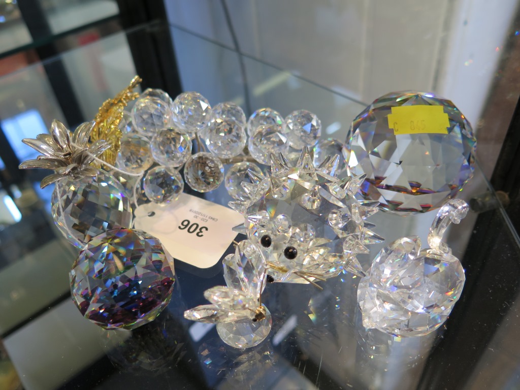 Six Swarovski paperweights and a model of a bunch of grapes