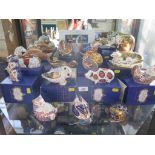 Fourteen Royal Crown Derby paperweights, including an elephant, seated horse, and Chinese dragon,