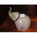 A Wedgwood 1970's speckled grey glass elephant paperweight, with trunk raised and etched mark to the