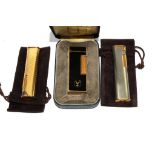 A Dunhill enamel rollagas lighter, with case, a gold plated Dunhill bar lighter and a similar