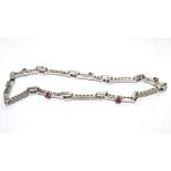 An 18 carat white gold diamond and ruby bracelet