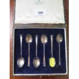 A cased set of six silver coffee spoons with folded tongue terminals, Christopher Dresser design for