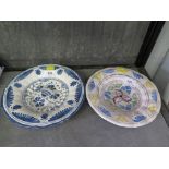 Two 18th century German faience plates, both with floral decoration, blue and white 22 cm