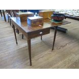 A 19th century mahogany fold over tea table with boxwood stringing, square tapering legs and spade