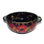 A Moorcroft Pottery pomegranate and grape design two handled fruit bowl, signed and impressed