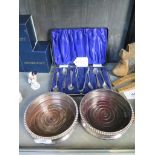 A pair of plated coasters and a set of silver coffee spoons