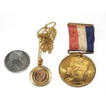 A Victorian silver coin, a George and Mary Coronation medal and a Commemorative Kennedy medal on