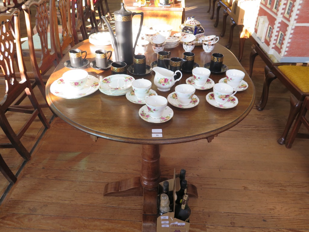 An oak twin pedestal dining table, on ring turned tapering legs and bracket feet, with two extra