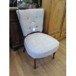 A 1950s bedroom chair, in grey upholstery with multi-coloured buttons