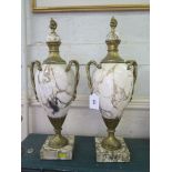 A pair of white marble and giltmetal vases, with domed covers and entwined serpent handles on square