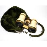 A pair of opera glasses in velvet bag