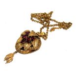 A large Victorian leaf pendant, set with armandine garnets on gold colour neck chain