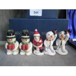 Two pairs of Moorcroft Pottery snowman figures and a figure of Father Christmas, 7 cm high, in three