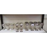 A set of eight silver plated goblets, and two sets of six smaller silver-plated goblets