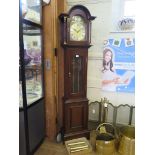 A mahogany longcase clock, the arched hood over a brass dial and glazed trunk door, the German