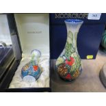 A Moorcroft Enamel Holly and Mistletoe design vase, 10.5 cm high, and a matching Moorcroft pottery