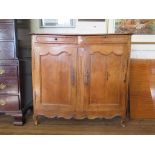 A 19th century French pine cabinet, with two frieze drawers over a pair of panelled doors on