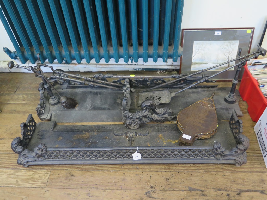 Two Victorian cast metal fire fenders, 110 and 123 cm long, and associated fire irons