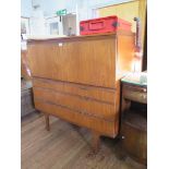 A teak secretaire by Meredew Furniture, the fall front over two short and two long drawers, on