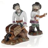 Two Porcelain Figurines of a Peasant Balalaika Player and a Peasant with a Wood Cart