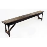 AN ANTIQUE OAK LONG BENCH of pegged construction 245cm wide x 27cm deep x 55cm high