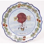 A 19TH CENTURY FRENCH FAIENCE PLATE with shaped edge and centrally decorated with a balloon,