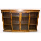 A VICTORIAN WALNUT BREAKFRONT BOOKCASE with central glazed doors and open shelves to the side, all