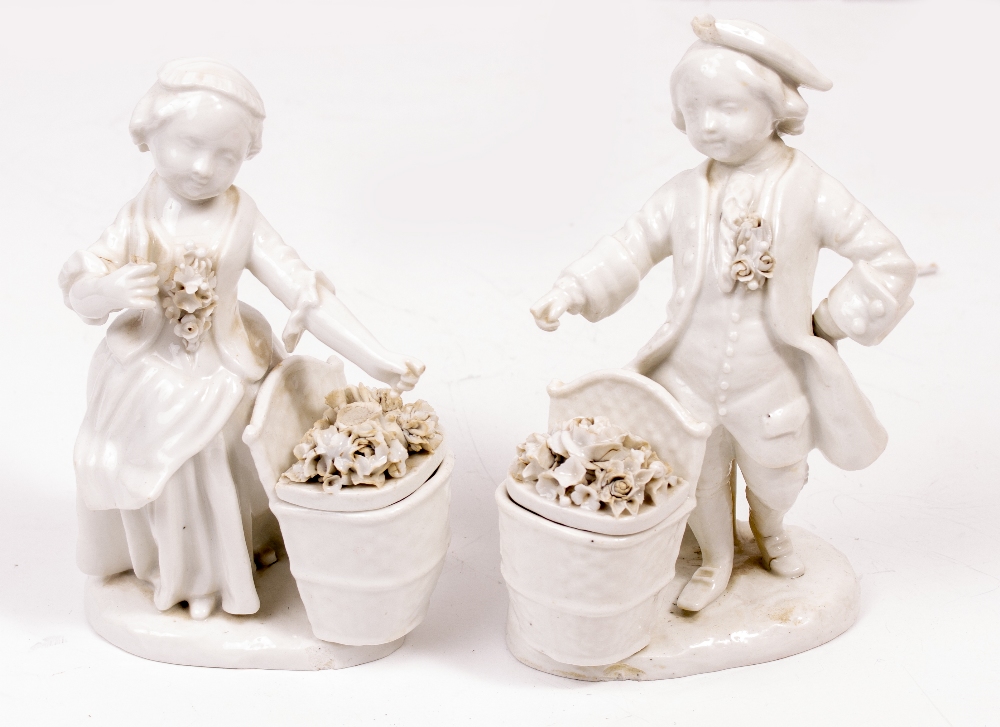 A PAIR OF MEISSEN STYLE PORCELAIN BLANC DE CHINE FIGURINES of a girl and a boy, each with a basket