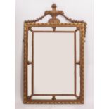 A NEO-CLASSICAL STYLE WALL MIRROR with an urn crest and sectional glass boarder, 77cm wide x 127cm