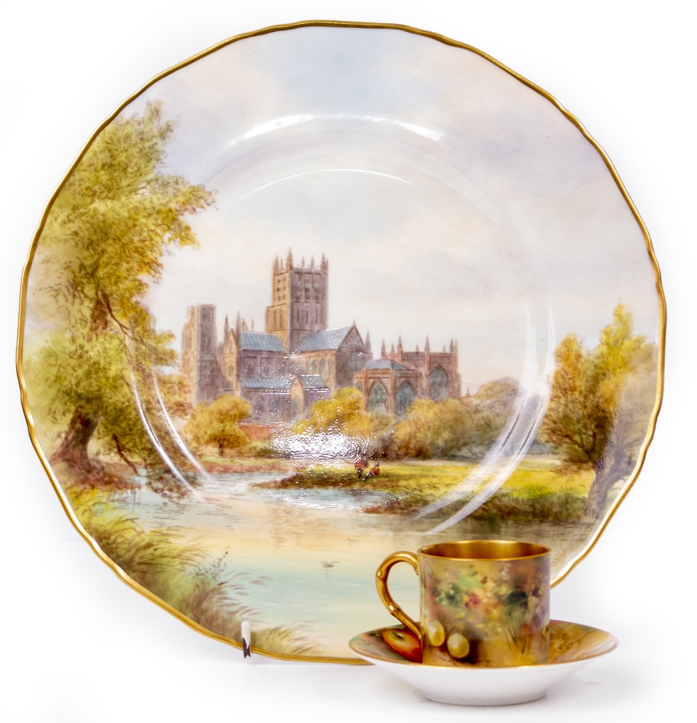 A ROYAL WORCESTER COFFEE CAN AND SAUCER in the fruit pattern with gilt decoration and puce mark to