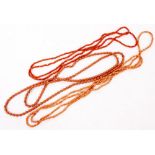 TWO CORAL BEAD NECKLACES each a single strand of coral corallium rubrum beads, and a further bead