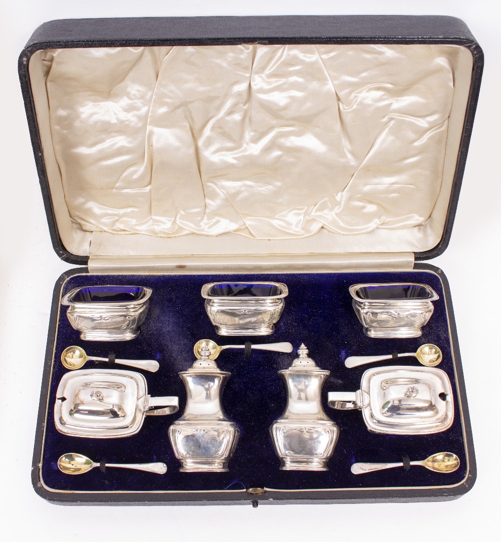 A CASED SEVEN PIECE CONDIMENT SET to include pepperettes, preserve/condiment dishes, gilded spoons