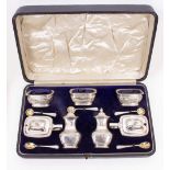 A CASED SEVEN PIECE CONDIMENT SET to include pepperettes, preserve/condiment dishes, gilded spoons