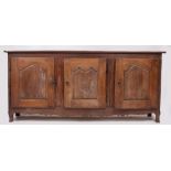 A 19TH CENTURY CONTINENTAL DRESSER BASE with three panelled doors and cabriole feet, 220cm wide x