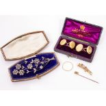 A WHITE METAL FLORAL BROOCH set with white stones together with a hunting brooch, marked 9ct, a pair