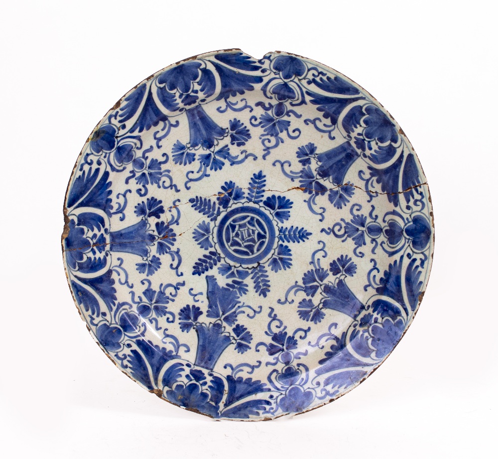 AN EARLY 19TH CENTURY TIN GLAZED DELFTWARE CHARGER with restoration, approximately 35cm