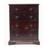 A 20TH CENTURY MAHOGANY APPRENTICE TABLETOP CHEST of four graduated drawers with turned handles