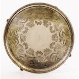 A VICTORIAN SILVER PLATED CIRCULAR TRAY with floral engraving and beaded edge standing on paw feet