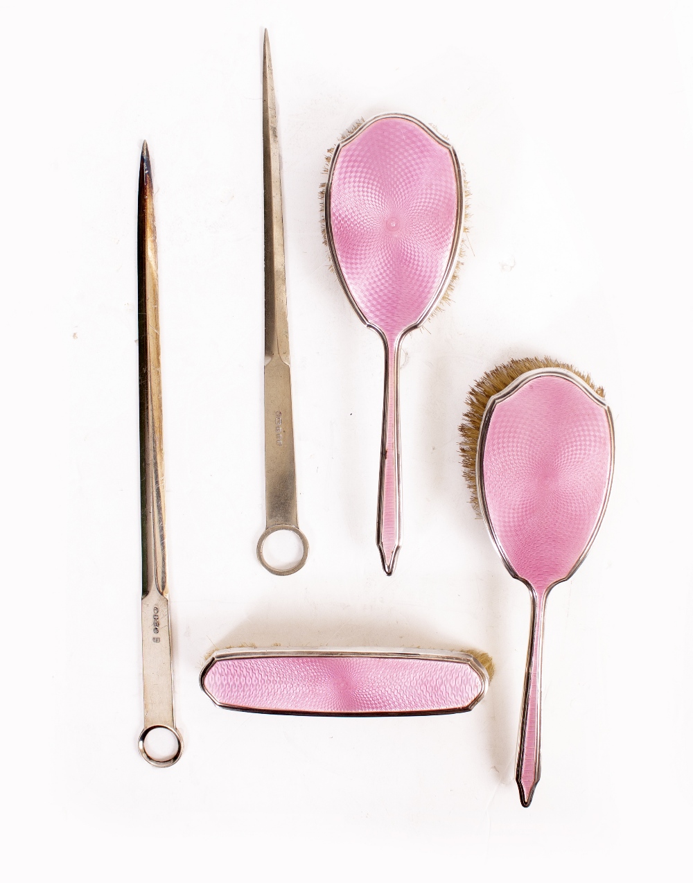 A MAPPIN & WEBB THREE PIECE SILVER PINK ENAMELLED DRESSING TABLE SET consisting of three brushes