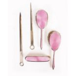 A MAPPIN & WEBB THREE PIECE SILVER PINK ENAMELLED DRESSING TABLE SET consisting of three brushes