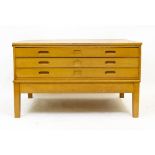 A MID 20TH CENTURY LIGHT OAK PLAN CHEST ON STAND with three long drawers and square legs, 122cm wide