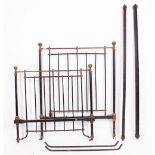 TWO LATE VICTORIAN / EARLY EDWARDIAN COPPER AND LACQUERED SINGLE BED FRAMES standing on porcelain