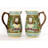 A PAIR OF MAJOLICA JUGS decorated with head and shoulder portraits of Garibaldi 25cm high (2)