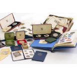 A COLLECTION OF STAMPS AND COINS to include two albums of GB, Commonwealth and world stamps, some