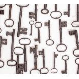 A COLLECTION OF ANTIQUE IRON KEYS of various sizes, the largest 15.8cm long