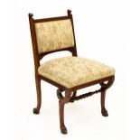 A CONTINENTAL WALNUT SIDE CHAIR with carved decoration, overstuffed upholstered back and seat and